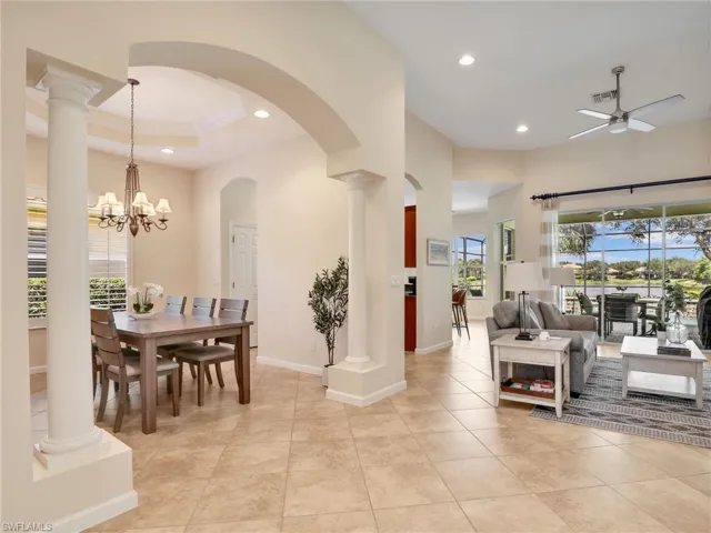 Living room with recessed lighting, a ceiling fan, healthy amount of natural light, a high ceiling, and light tile patterned flooring