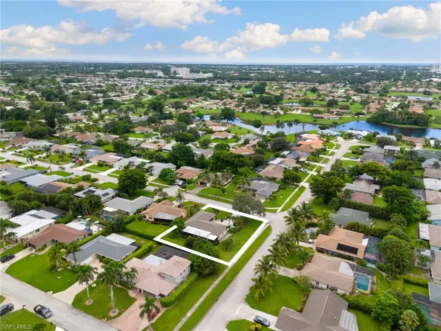 Aerial overview of property's location with nearby suburban area, a nearby body of water, and property parcel outlined