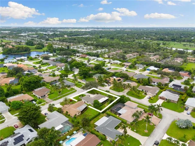 Aerial view of property's location with nearby suburban area and a large body of water