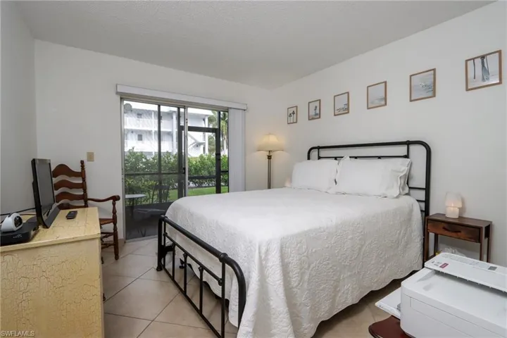Bedroom with access to outside and light tile patterned floors