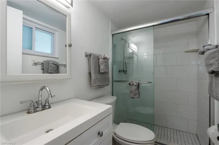 Full bath with a stall shower and vanity