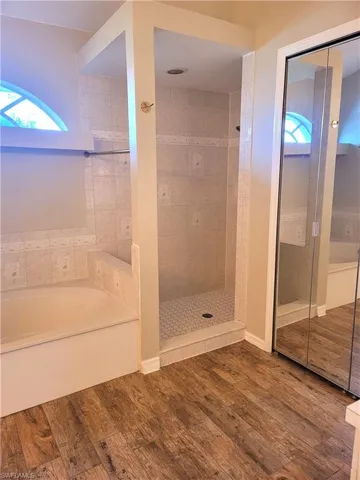 soaking tub, separate shower and linen closet