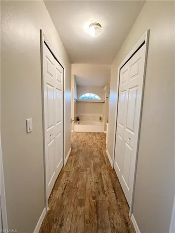 from primary bedroom   toward primary bath  with closets on the sides