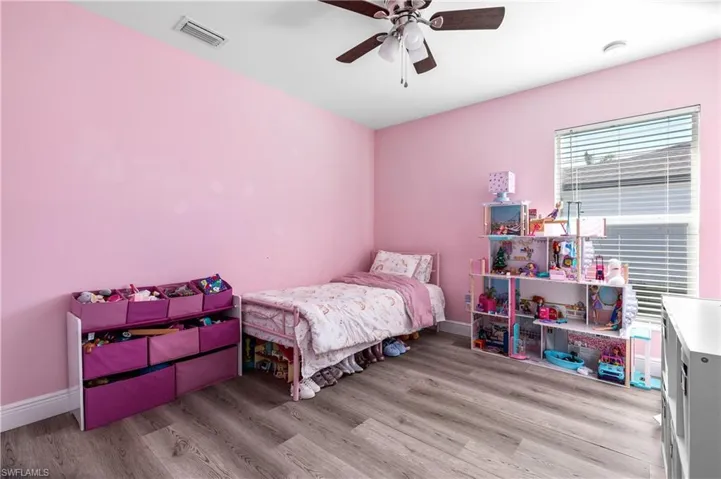 Bedroom featuring ceiling fan and light hardwood / wood-style flooring