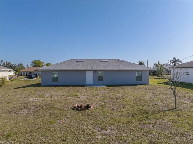 Rear view of house with a yard