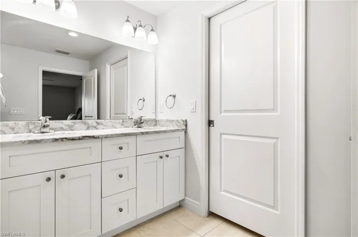 Bathroom featuring tile patterned floors and vanity