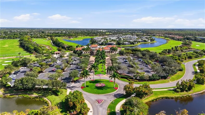 Aerial view of residential area with a large body of water and a golf course