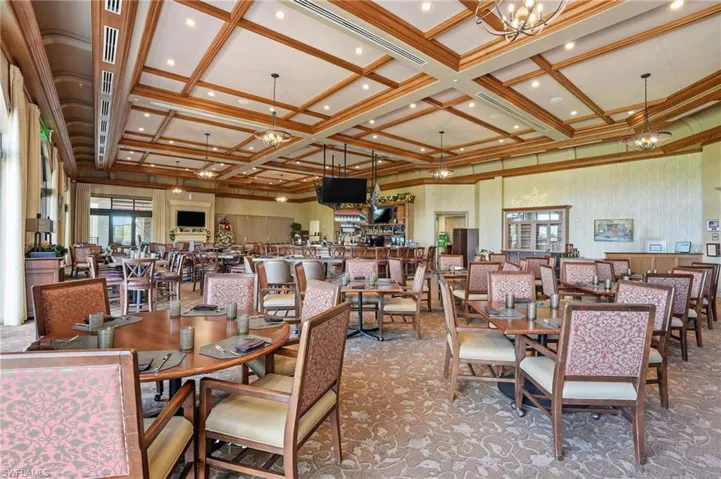 Dining space with coffered ceiling, a chandelier, beam ceiling, carpet flooring, and recessed lighting