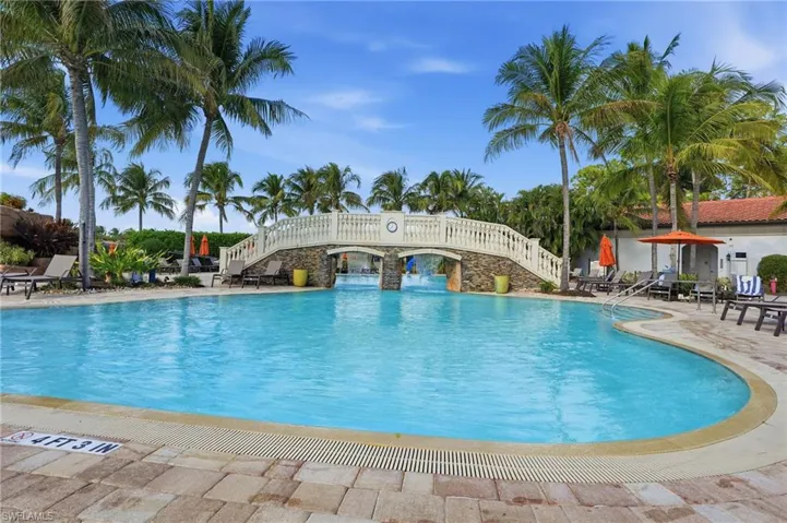 Community pool with a patio and stairs