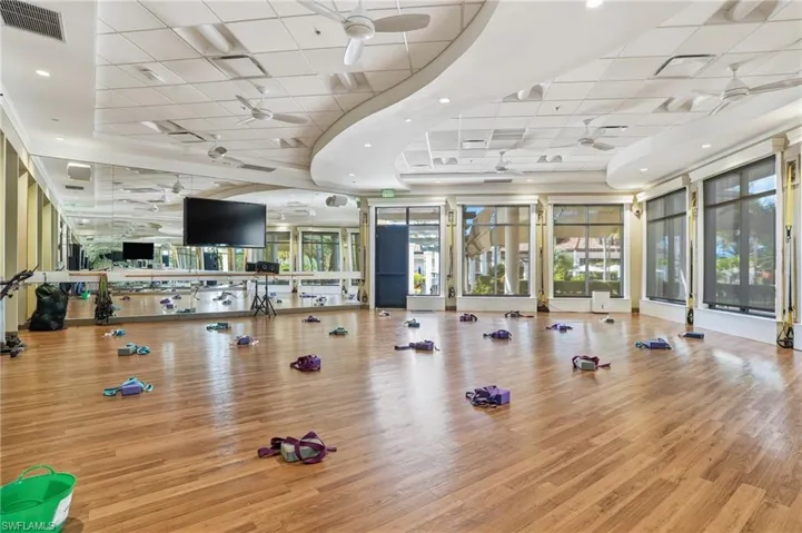 Gym with a paneled ceiling and a ceiling fan