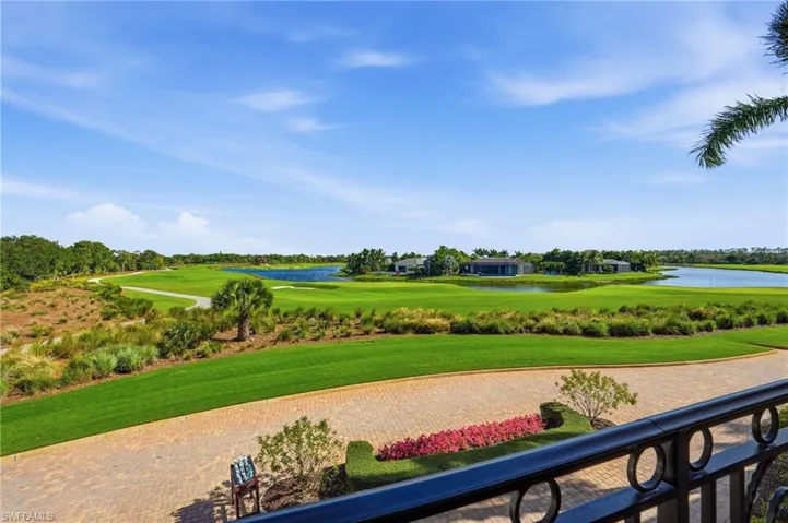 View of property's community with a water view, a lawn, and golf course view