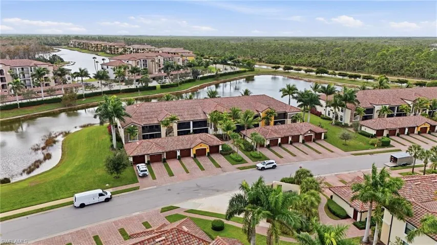 Aerial view of a nearby body of water and apartment complex / building