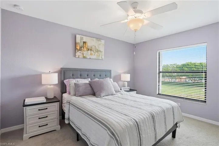 Bedroom featuring light colored carpet and a ceiling fan