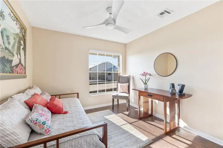 Sitting room with hardwood / wood-style flooring, ceiling fan, and a textured ceiling