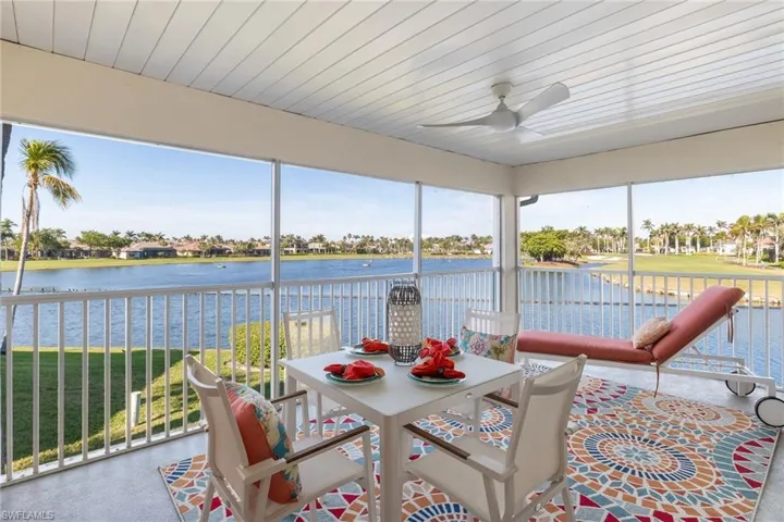 Sunroom / solarium with a water view, ceiling fan, and wood ceiling