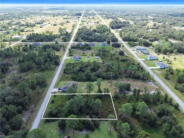 Aerial view of property and surrounding area with property parcel outlined