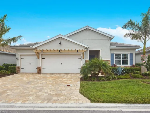 Be charmed by the coastal curb appeal of this home, featuring stone-like accents and a wooden overhang.