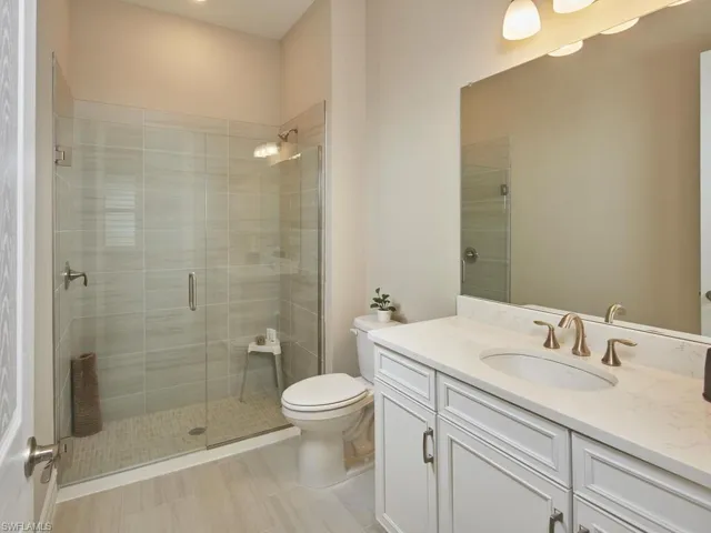 Guest bathroom with a frameless walk-in shower and upgraded tile.