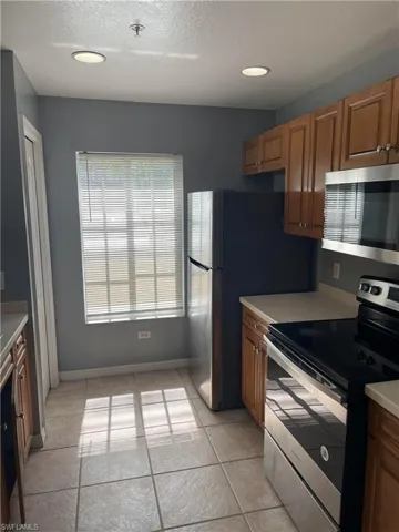 Kitchen featuring stainless steel appliances and light tile patterned floors