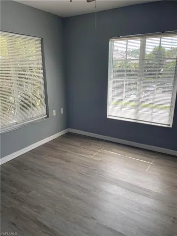 Spare room with ceiling fan and wood-type flooring