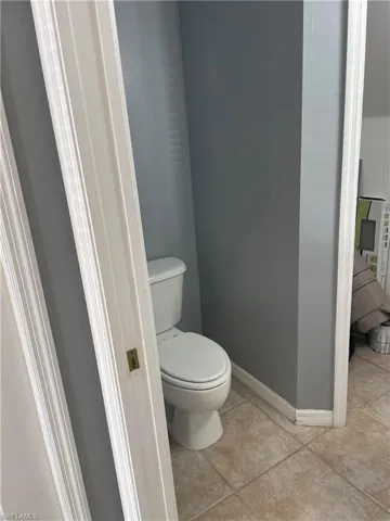 Bathroom with tile patterned flooring and toilet