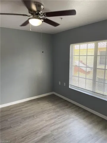 Spare room featuring ceiling fan and light wood-type flooring
