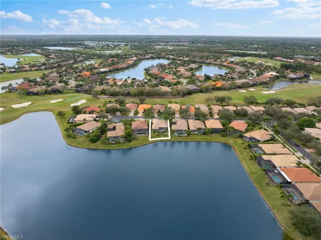 Birds eye view of property featuring a water view and view of golf course