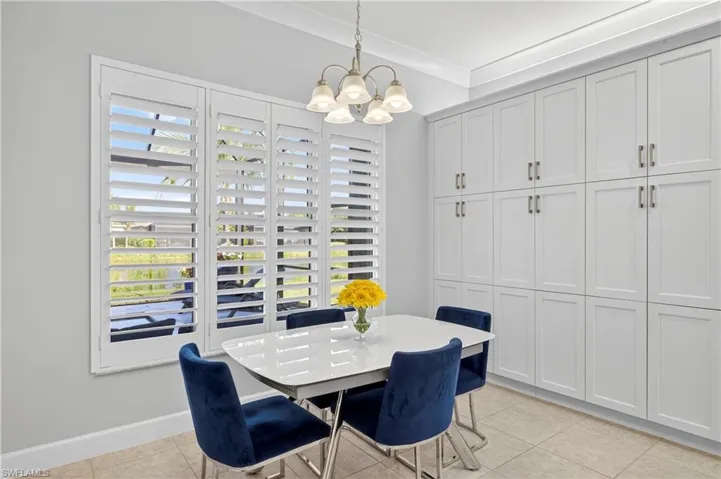 Dining space featuring light tile patterned floors and a chandelier