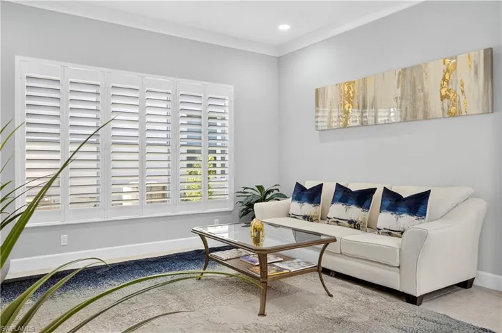 Living area with crown molding and recessed lighting