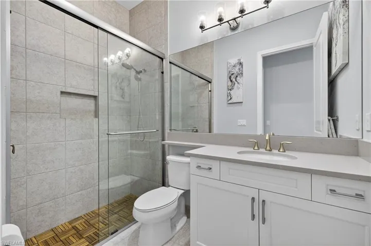 Full bathroom featuring a shower stall and vanity