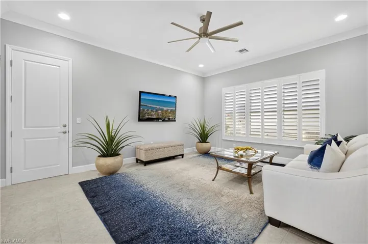 Living area with crown molding, recessed lighting, a ceiling fan, and light tile patterned flooring