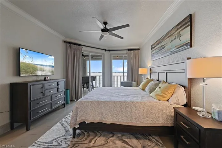 Bedroom with a textured ceiling, access to exterior, a textured wall, crown molding, and ceiling fan