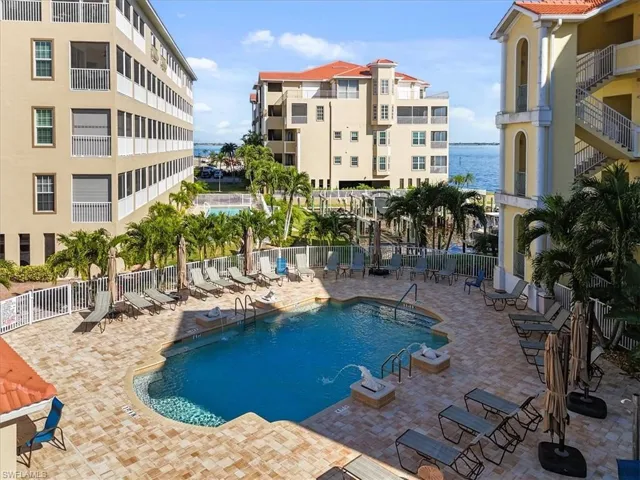 Community pool with a patio and a water view