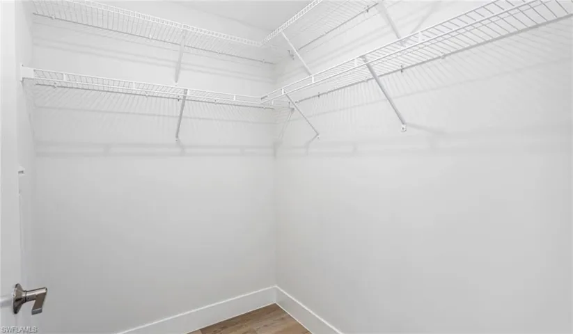 Walk in closet featuring wood finished floors