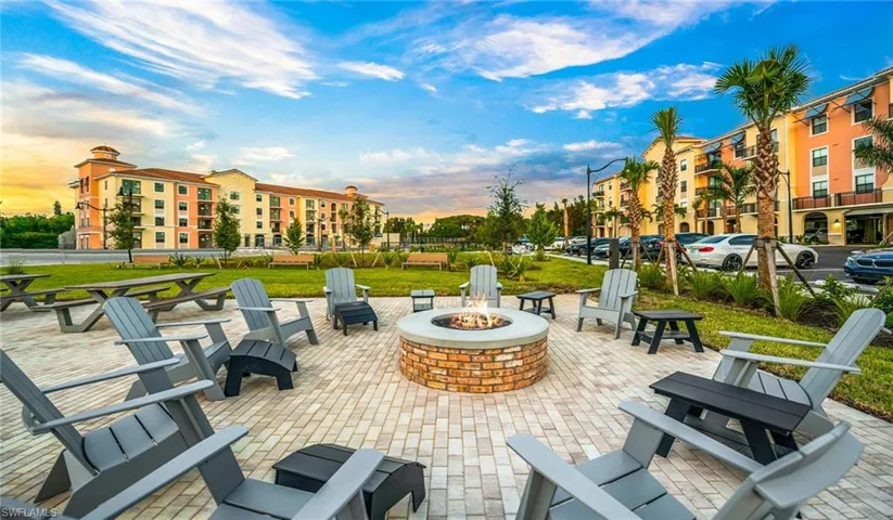 View of community featuring a patio and a fire pit