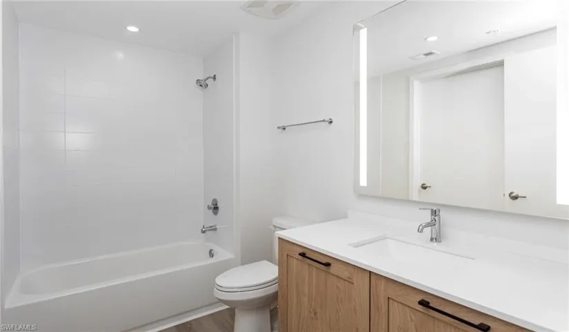 Full bath with vanity, visible vents, recessed lighting, bathtub / shower combination, and toilet