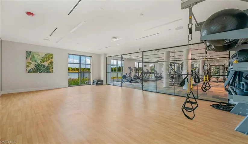 Exercise room with baseboards and wood finished floors