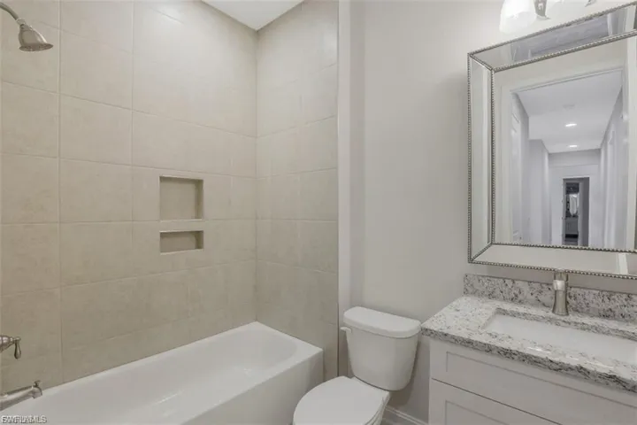 Full bath featuring vanity and shower / washtub combination