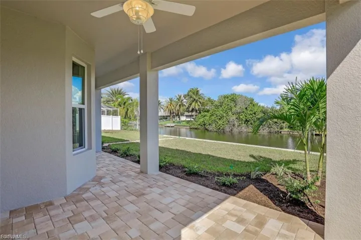 View of patio / terrace with ceiling fan and a water view