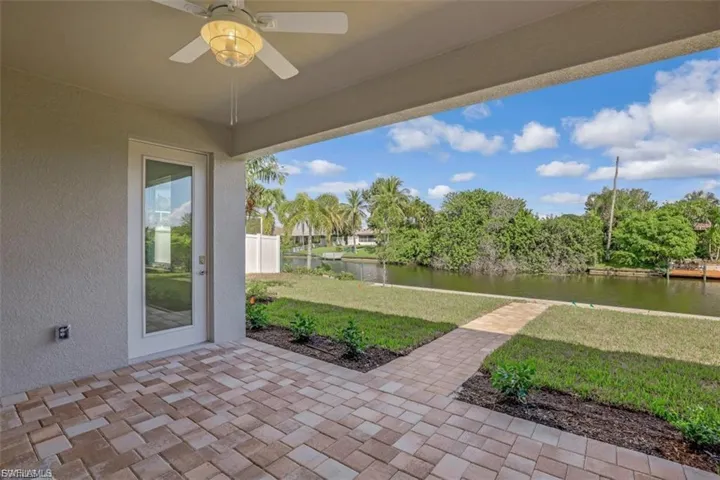View of patio featuring a ceiling fan and a water view