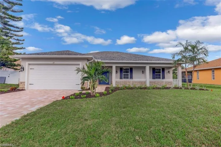 Single story home featuring stucco siding, a porch, an attached garage, and a front lawn
