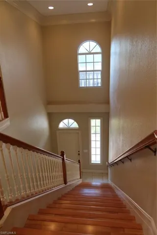 Hardwood staircase with painted balusters and wood handrails