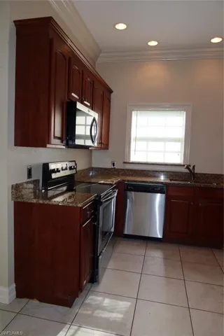 Kitchen featuring rich wood cabinetry and stainless steel appliances