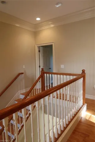 Staircase with wood-finish handrails and white balusters