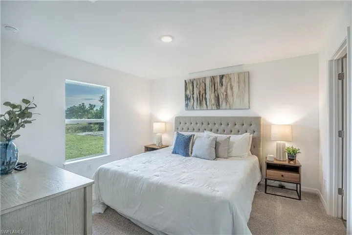 Bedroom with carpet flooring and baseboards