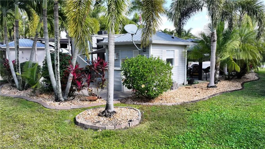 View of home's exterior featuring a yard, a metal roof, and a patio