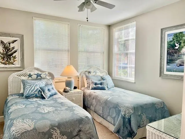 Bedroom featuring ceiling fan and carpet