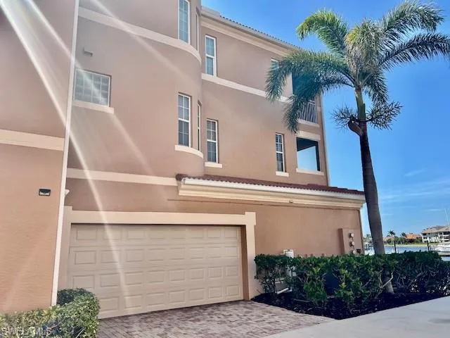 View of property featuring driveway and an attached garage
