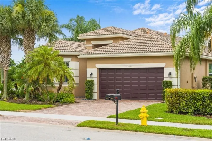 Mediterranean / spanish-style home featuring stucco siding, decorative driveway, an attached garage, and a tiled roof