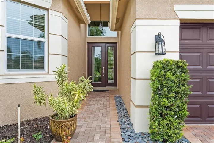 Doorway to property with stucco siding and french doors